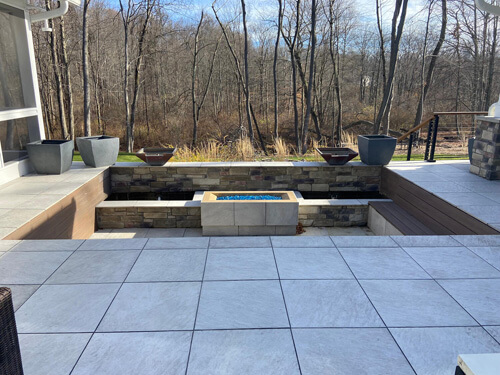 Recessed fire pit seating area of a courtyard ranch home